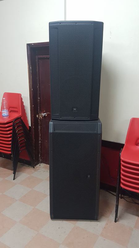 JBL speaker and subwoofer stack set up in an event hall