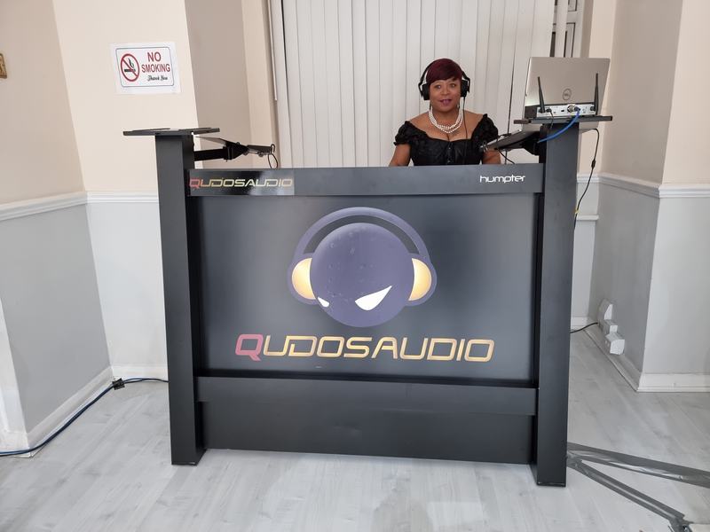 DJ at the branded Qudos Audio DJ booth