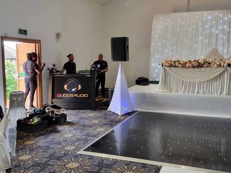 Wedding reception setup with LED dancefloor and starlit backdrop